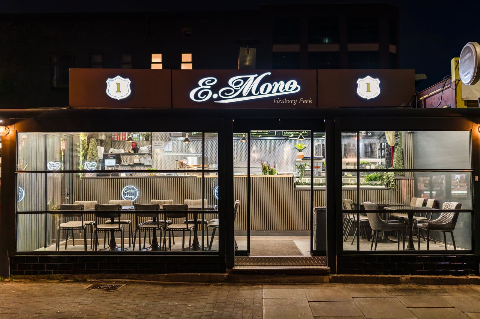Illuminated nighttime street view of E-Mono kebab restaurant with an 8 × 3m enclosed veranda in Finsbury Park London.