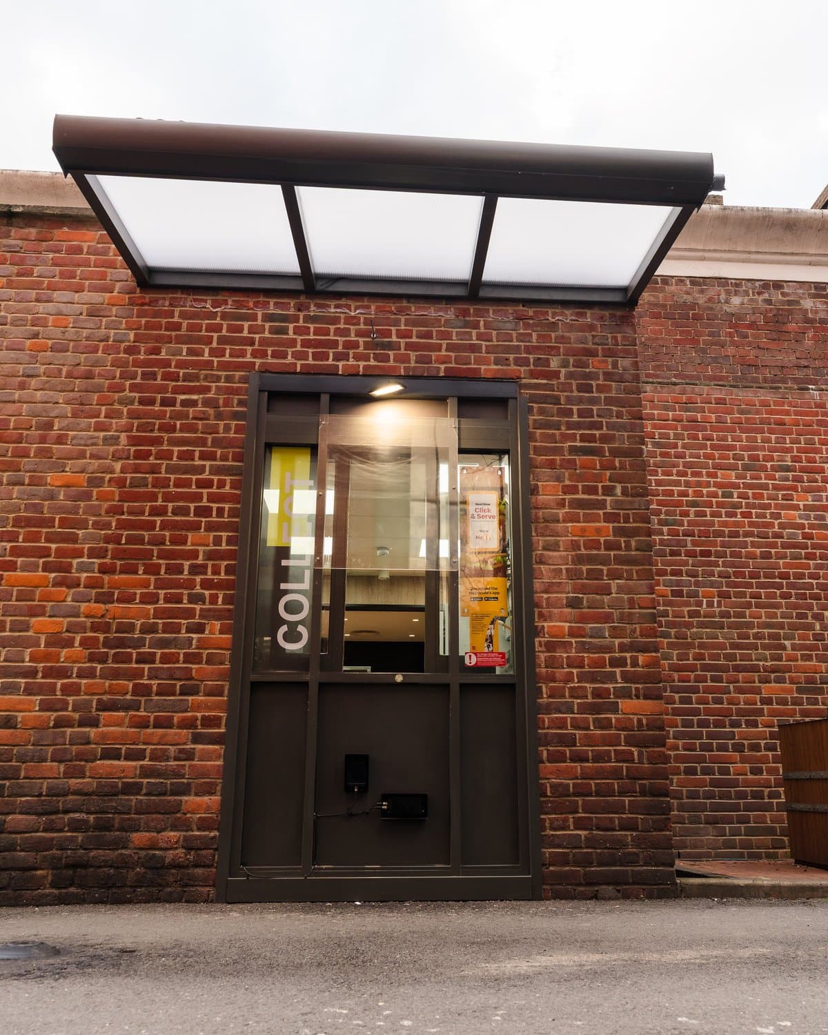 Aluminium canopy shelter mounted over the collect window at McDonald's in Edgware London.
