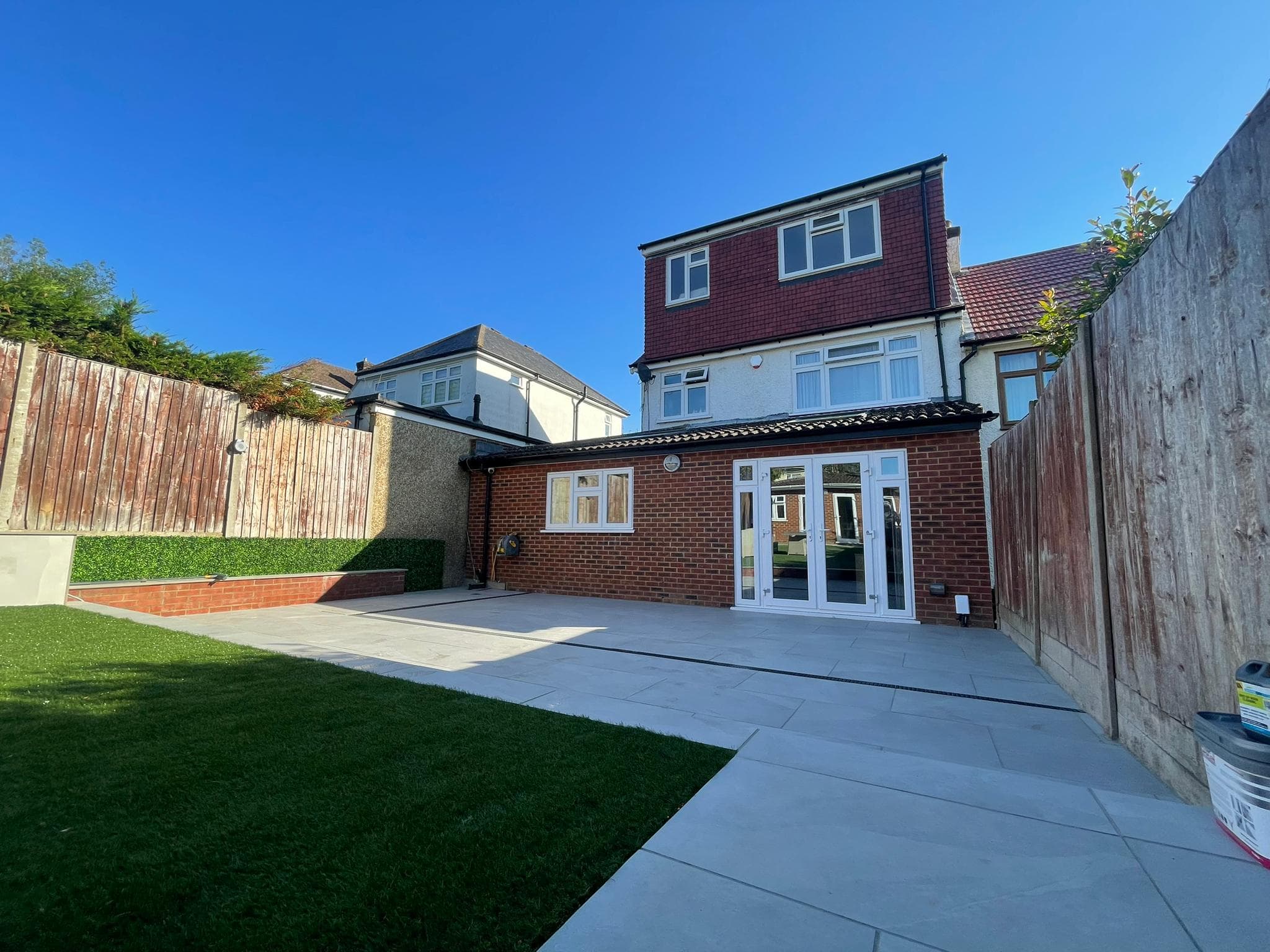 Original exposed paved patio and uncovered outdoor terrace prior to aluminium veranda installation.