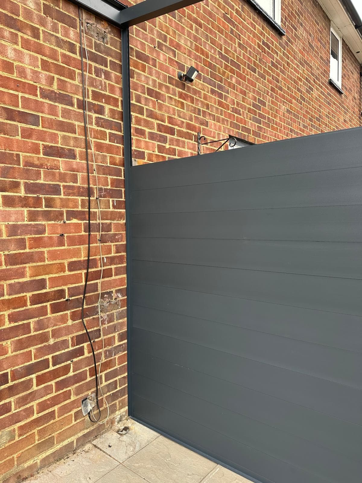 Solid architectural aluminium tongue and groove wall panel section mounted flush against garden veranda corner post