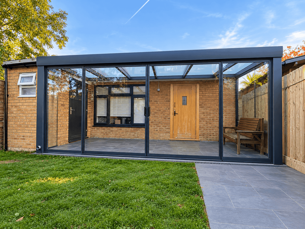 Framed double-glazed sliding glass doors installed on a veranda enclosure for enhanced comfort and acoustic insulation