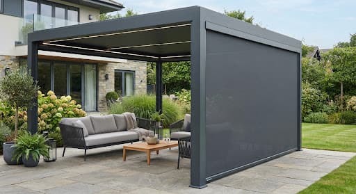 Motorised dark grey windproof zip screen lowered along side of luxury aluminium patio veranda