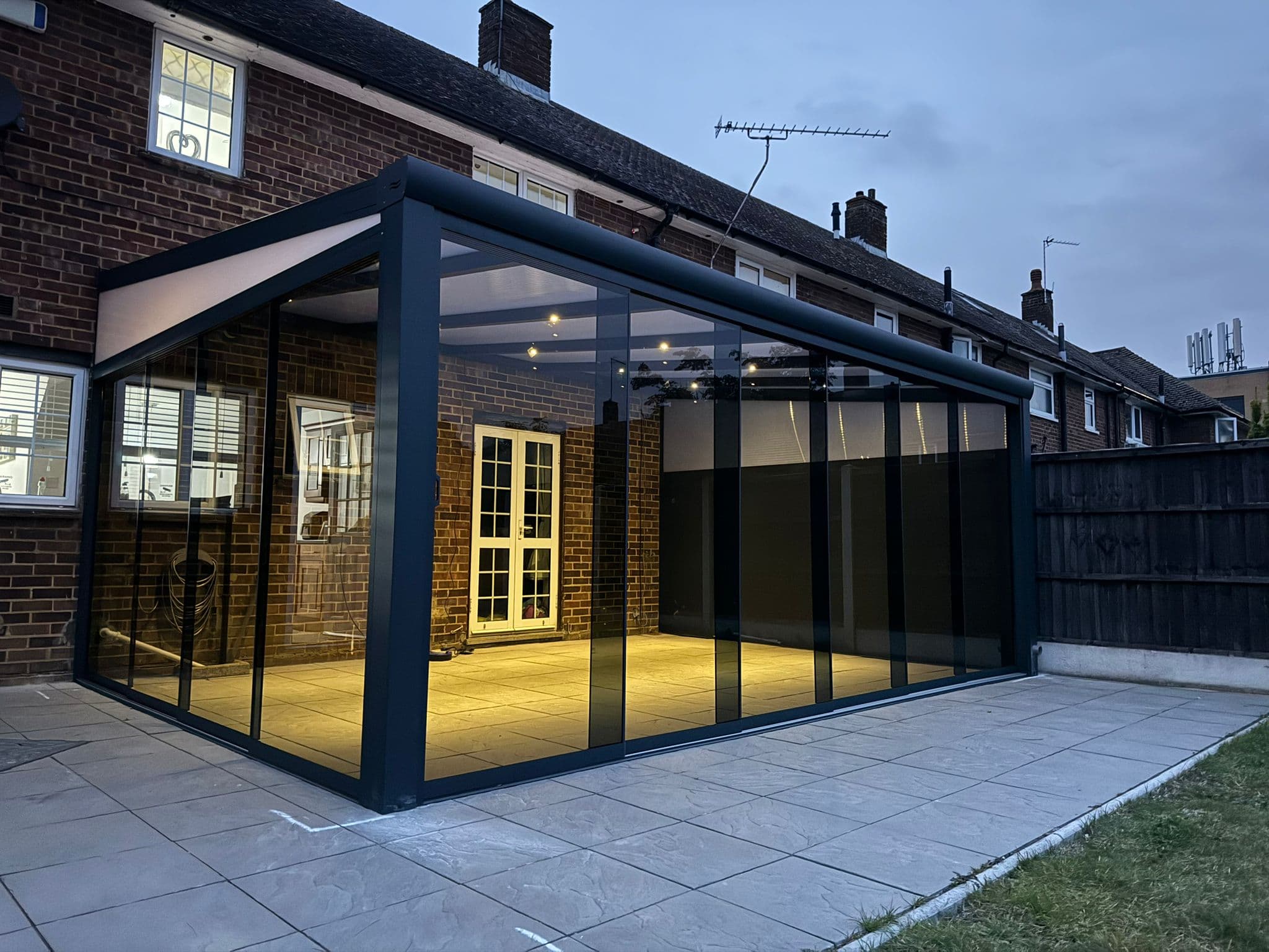 Enclosed veranda with sliding glass doors on a residential patio